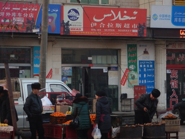A bigger town, black SWAT figures drawn onto the red sign
